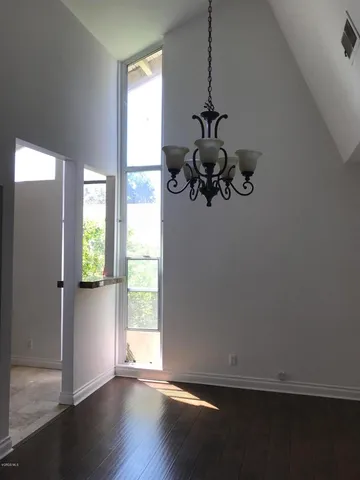 a view of a small space with wooden floor and a window