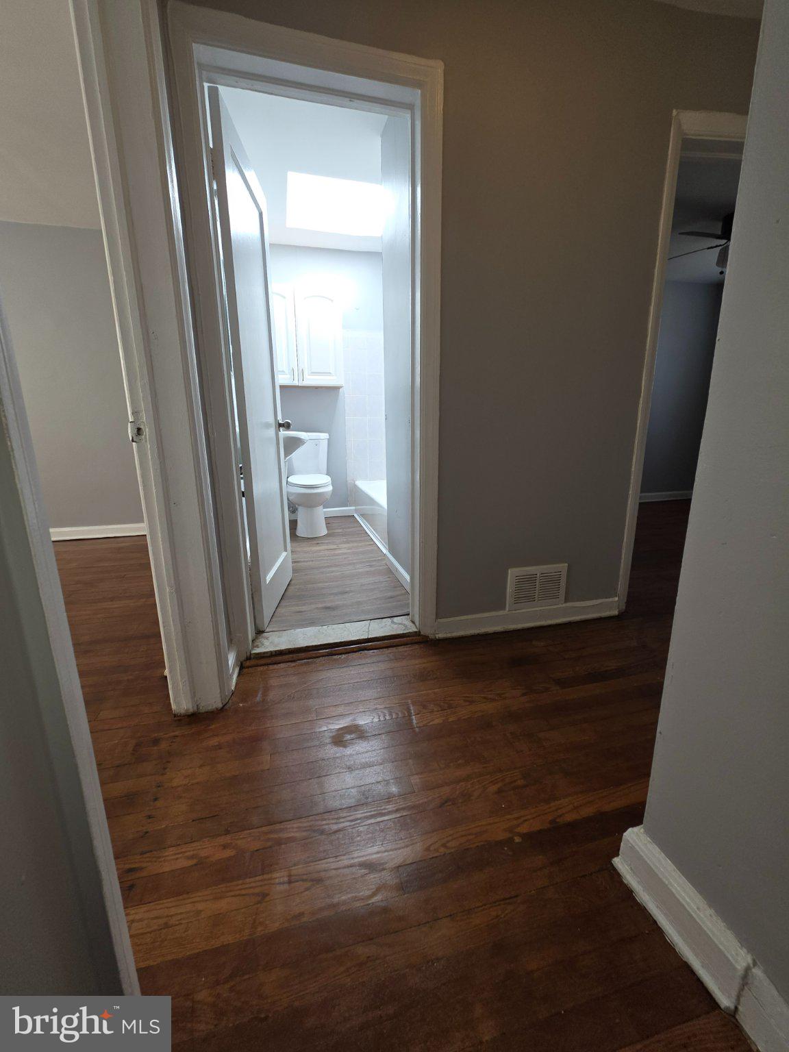 4404 Mountview Road Baltimore, MD 21229 - Photo 7 of 22 a view of a hallway with wooden floor