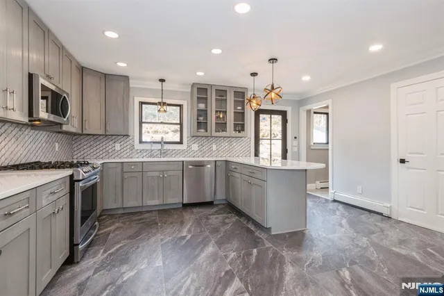 a bathroom with a granite countertop sink a toilet and shower