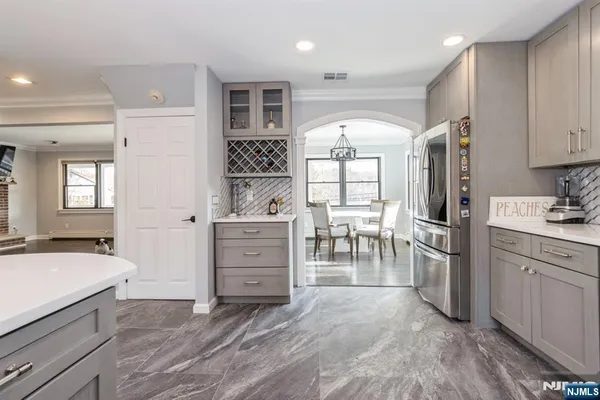 a kitchen with a refrigerator and a sink