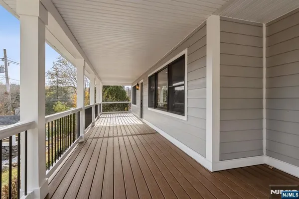 a view of a balcony with wooden floor
