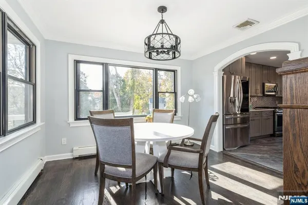 a view of a dining room with furniture large window and wooden floor