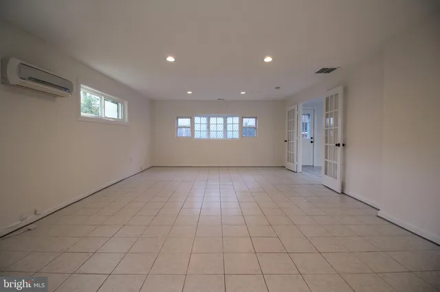 an empty room with windows and entrance