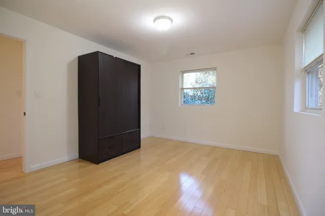 an empty room with windows and closet