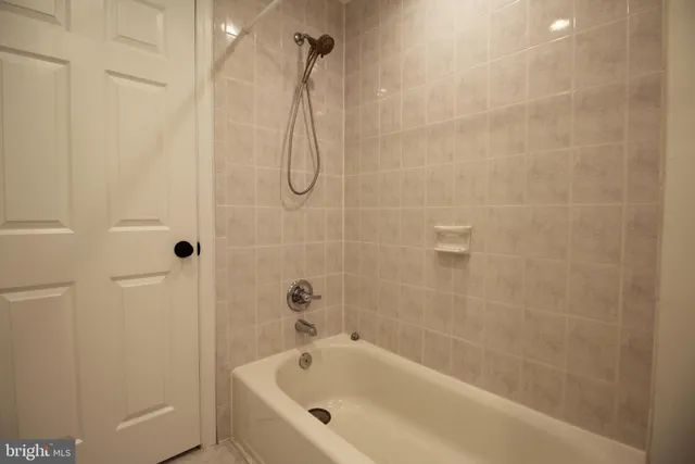 a bathroom with a bath tub with a shower