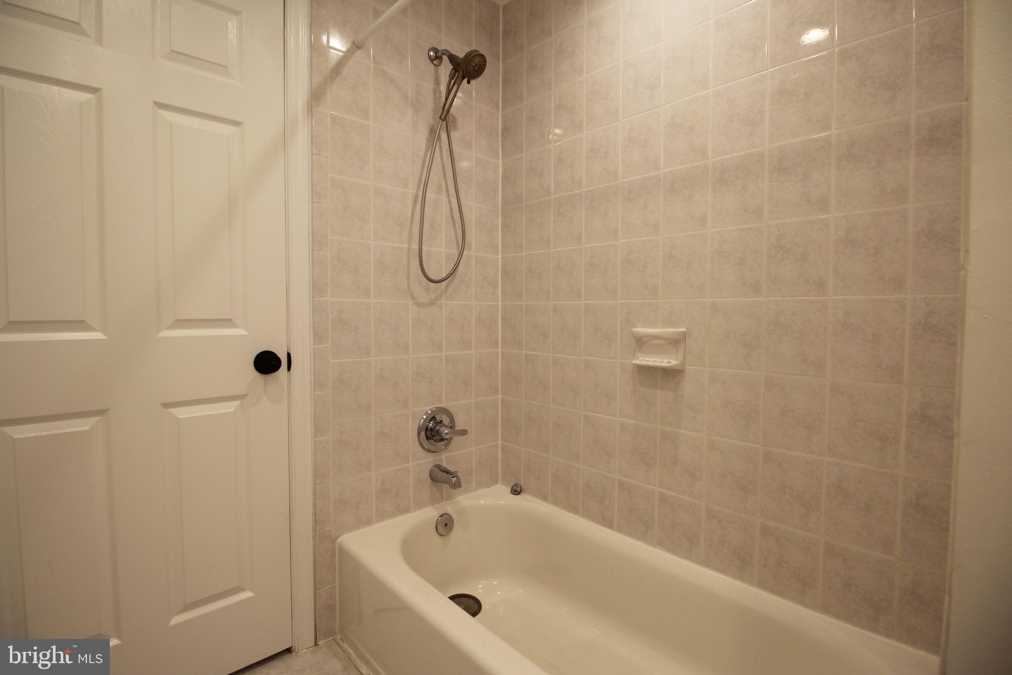 2129 Grayson Place Falls Church, VA 22043 - Photo 19 of 26 a bathroom with a bath tub with a shower