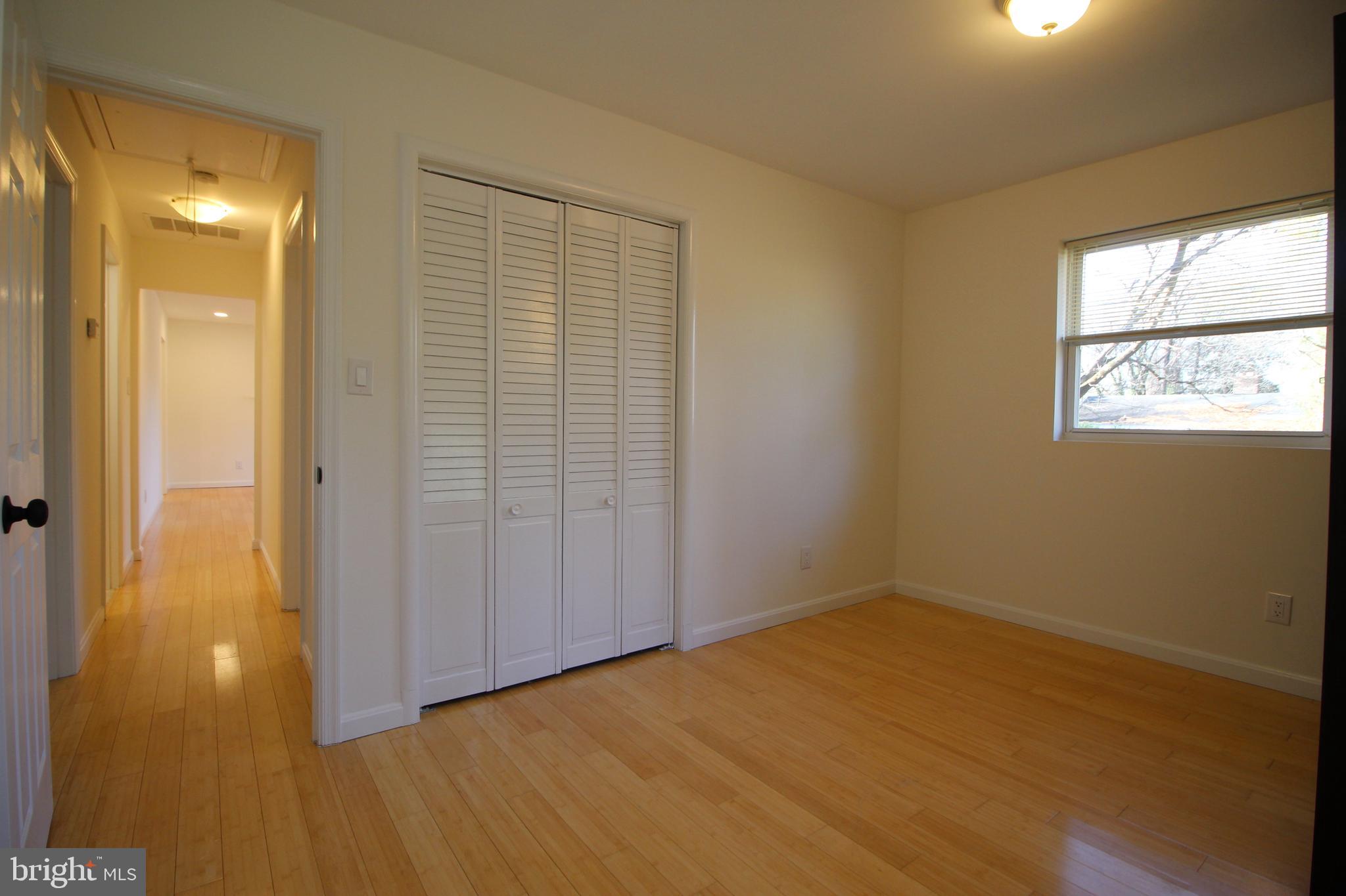 2129 Grayson Place Falls Church, VA 22043 - Photo 21 of 26 a view of an empty room with wooden floor and a bathroom