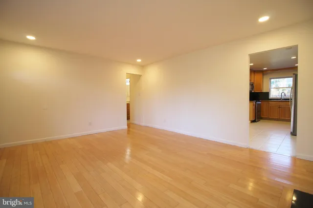 a view of an empty room with a kitchen