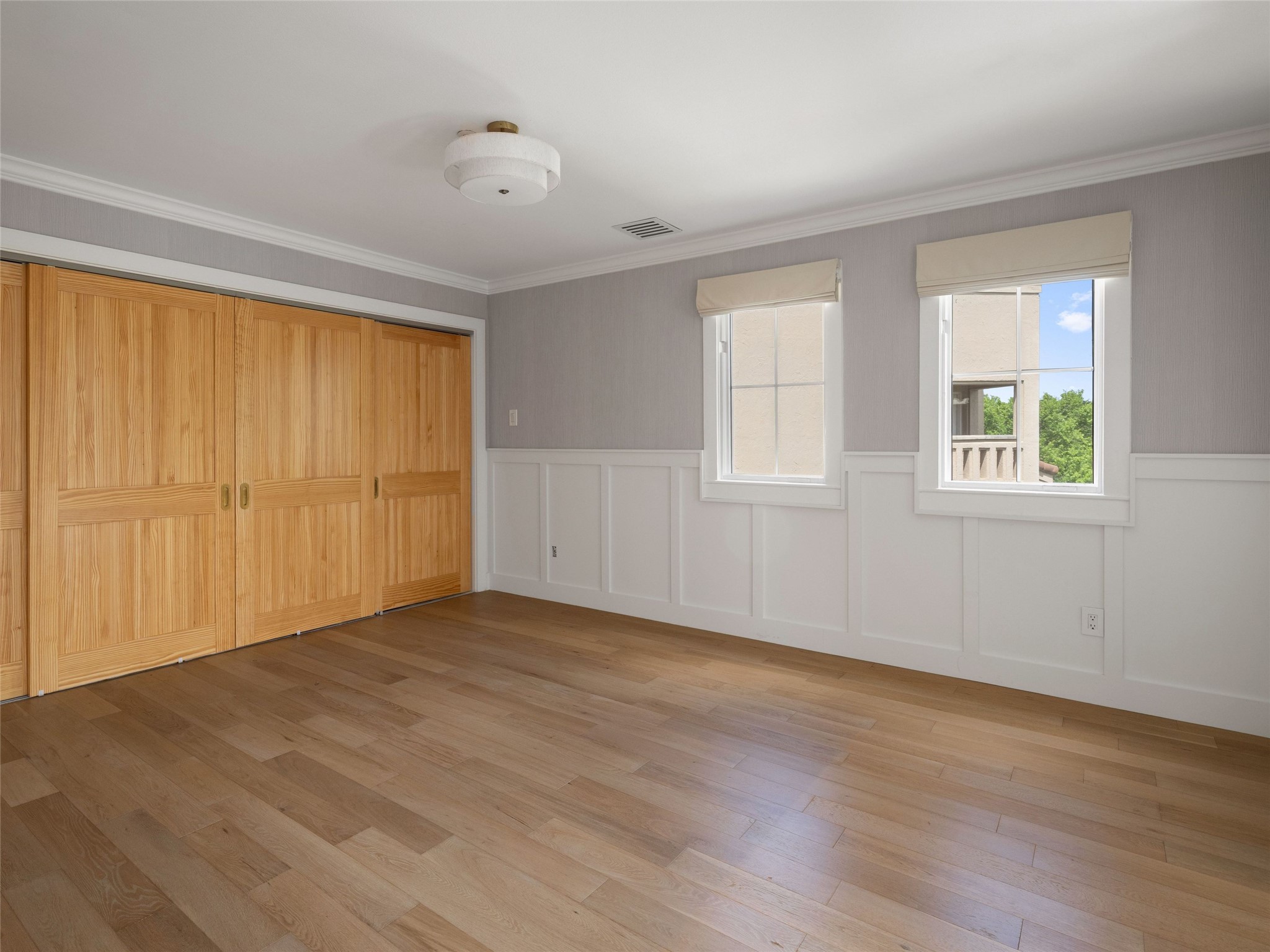 1937 Rue De St Tropez, Unit 10 Austin, TX 78746 - Photo 24 of 39 an empty room with wooden floor and windows