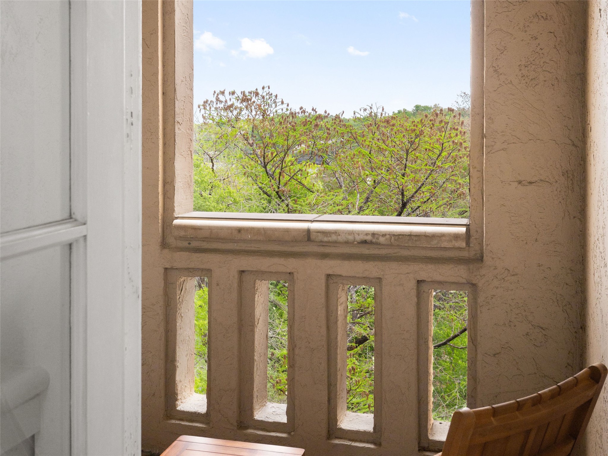 1937 Rue De St Tropez, Unit 10 Austin, TX 78746 - Photo 27 of 39 a view of a glass door and a balcony
