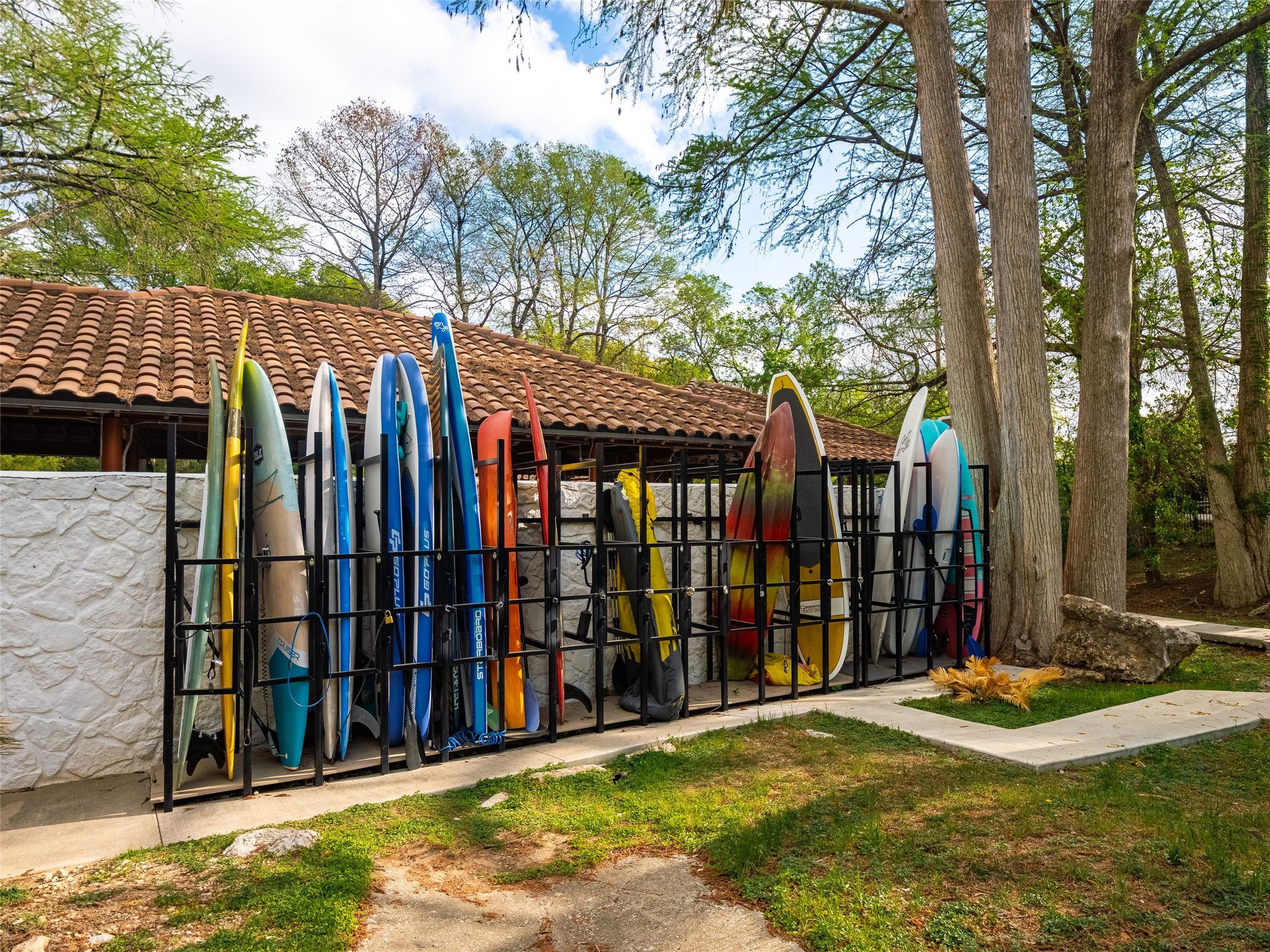 1937 Rue De St Tropez, Unit 10 Austin, TX 78746 - Photo 31 of 39 a view of a backyard with large trees and wooden fence