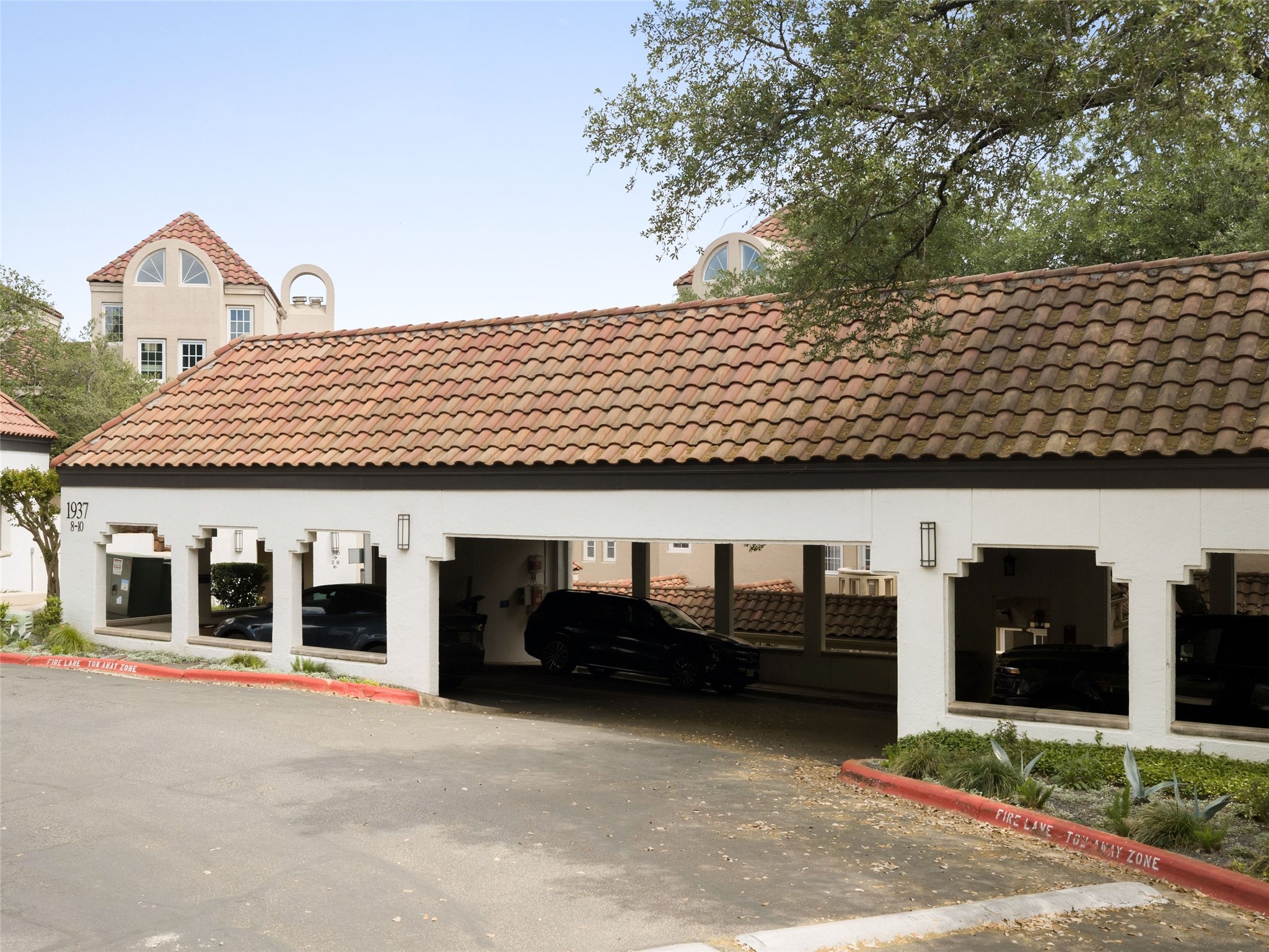 1937 Rue De St Tropez, Unit 10 Austin, TX 78746 - Photo 32 of 39 a front view of a house with garage