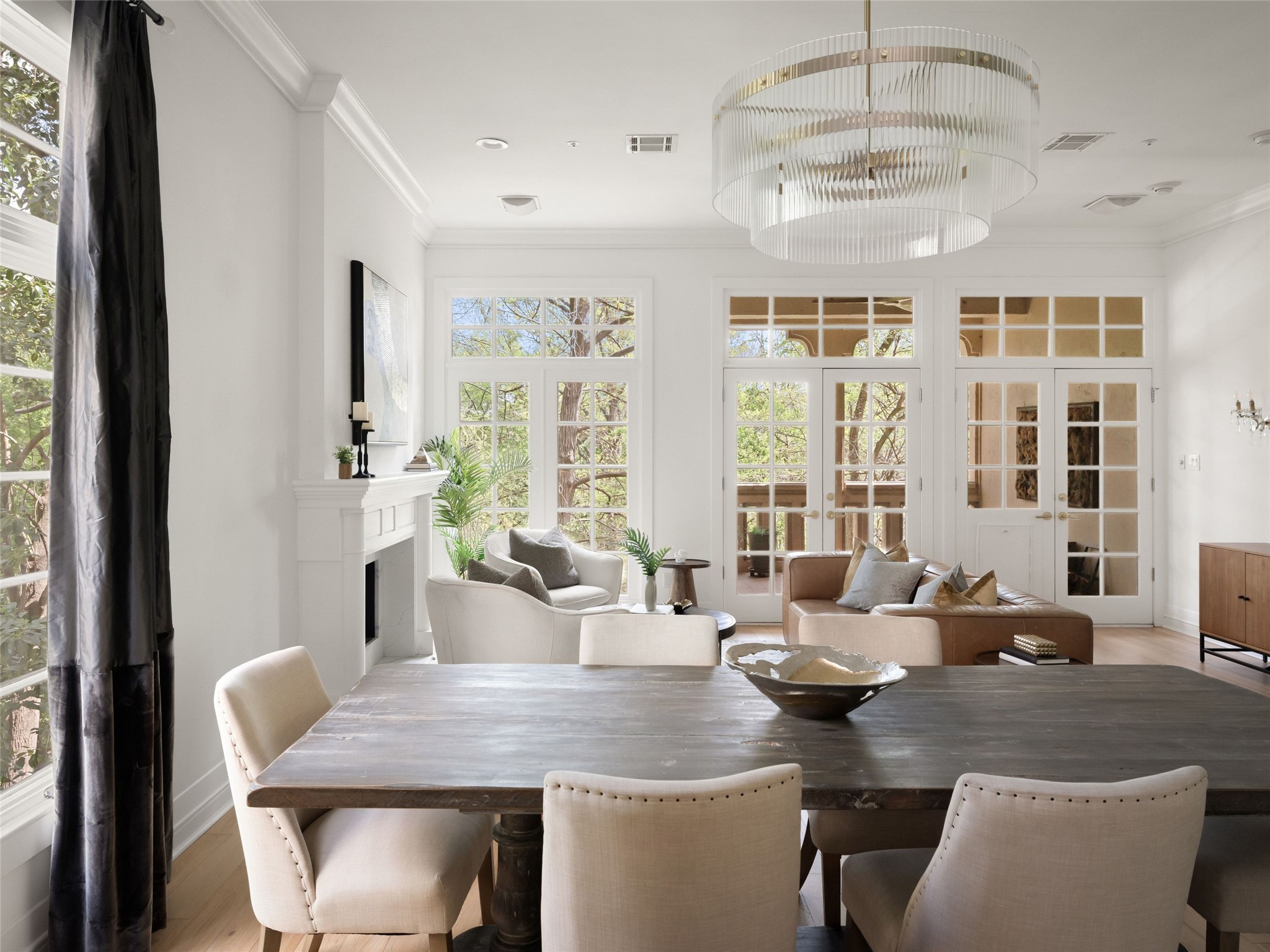 1937 Rue De St Tropez, Unit 10 Austin, TX 78746 - Photo 10 of 39 a view of a dining room with furniture large windows and wooden floor