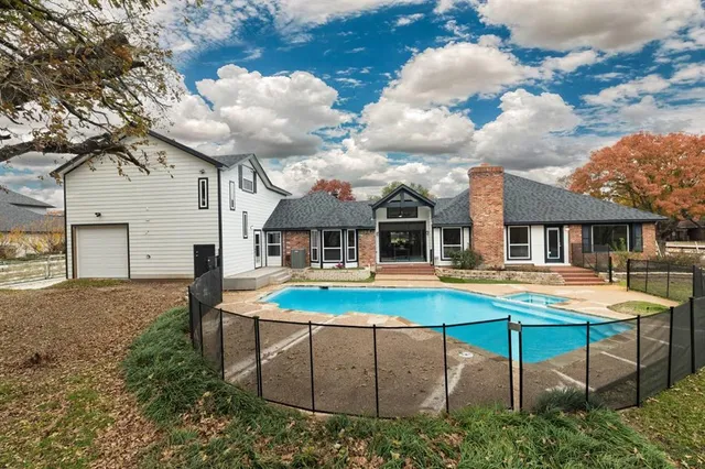 a view of a house with backyard and sitting area
