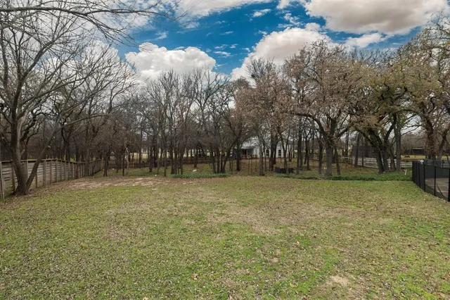 a big yard with lots of green space and trees