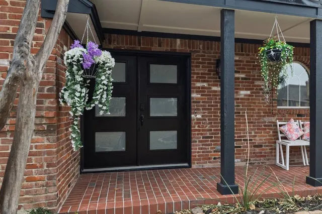 a front view of a house with plants