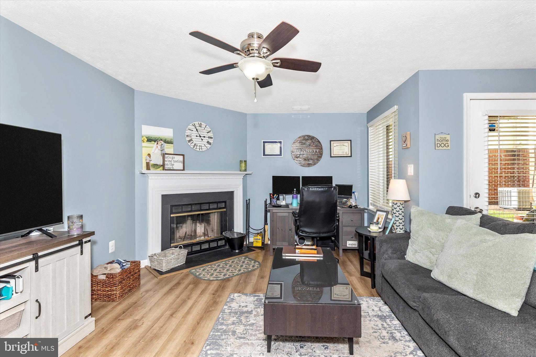 2102 Whitehall Road, Unit BC Frederick, MD 21702 - Photo 5 of 29 a living room with furniture a fireplace and a flat screen tv