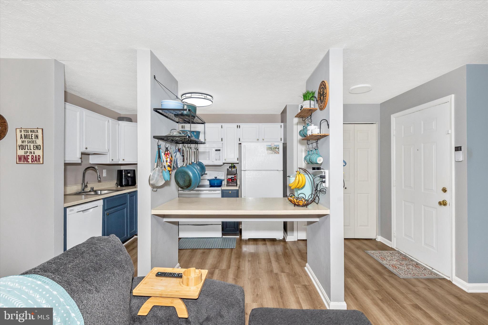 2102 Whitehall Road, Unit BC Frederick, MD 21702 - Photo 10 of 29 a living room with stainless steel appliances kitchen island granite countertop furniture and a wooden floor