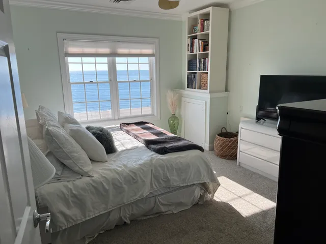 a bedroom with furniture and a flat screen tv