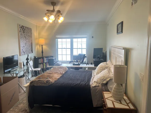 a bed room with a bed and a television