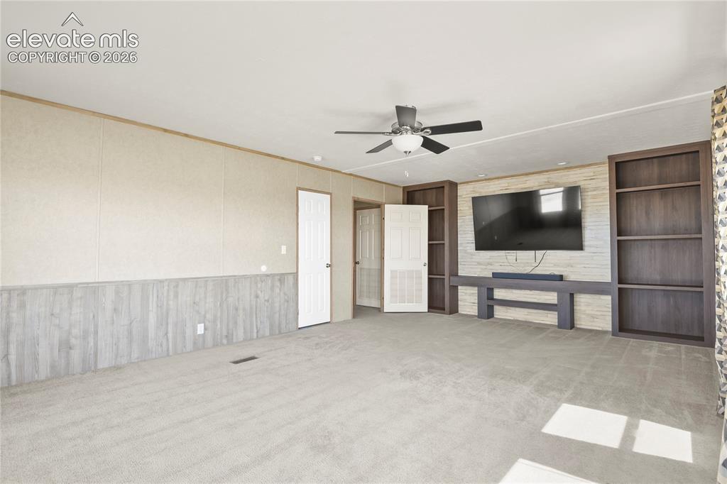 22280 Jones Road Peyton, CO 80831 - Photo 26 of 47 a view of a livingroom with wooden furniture and flat screen tv