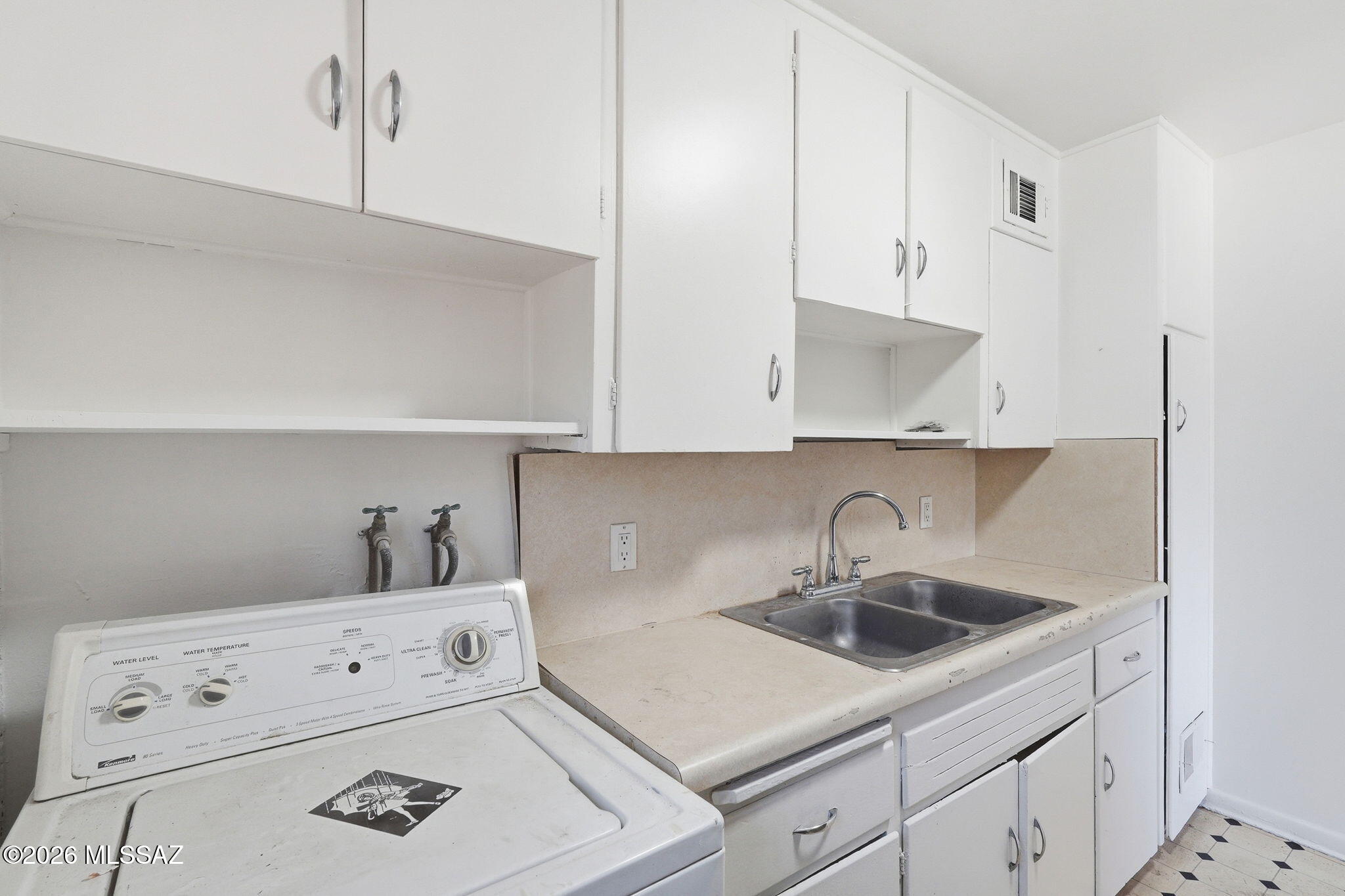 2721 East Fort Lowell Road Tucson, AZ 85716 - Photo 13 of 28 a kitchen with white cabinets and white appliances