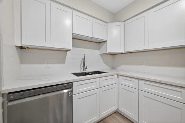 a kitchen with white cabinets and white appliances