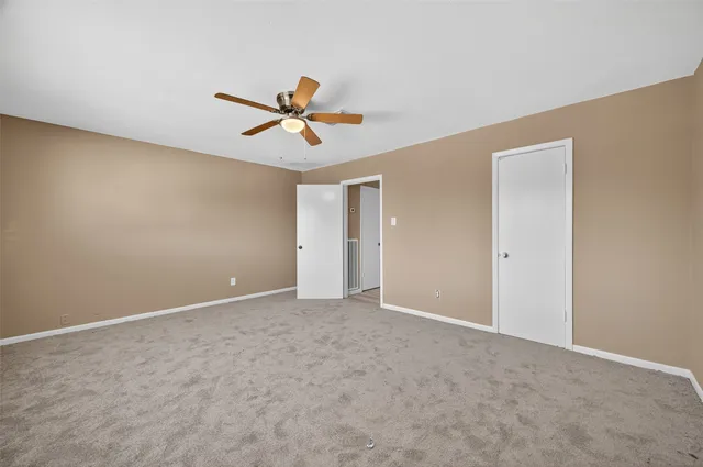 a view of room with a ceiling fan and window