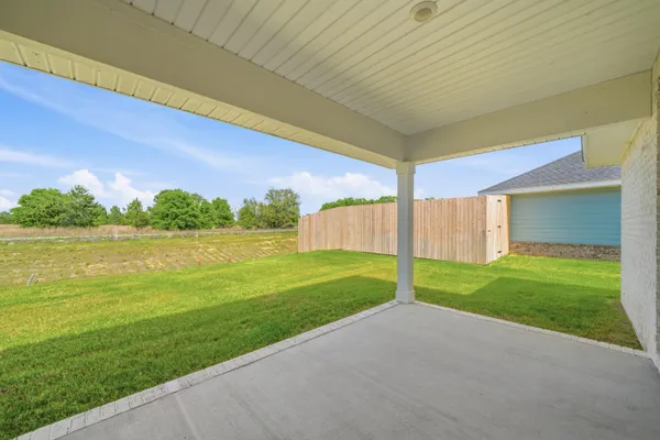 a view of a house with a yard and a garage