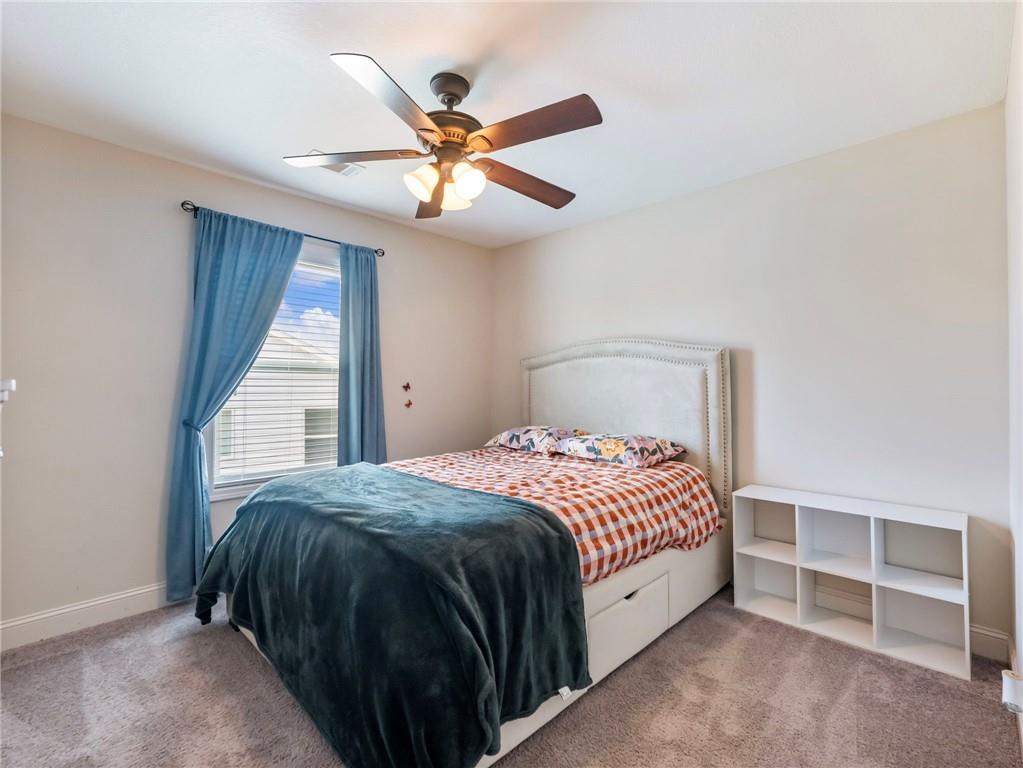 476 River Mist Circle Jefferson, GA 30549 - Photo 21 of 44 a spacious bedroom with a bed and a chandelier