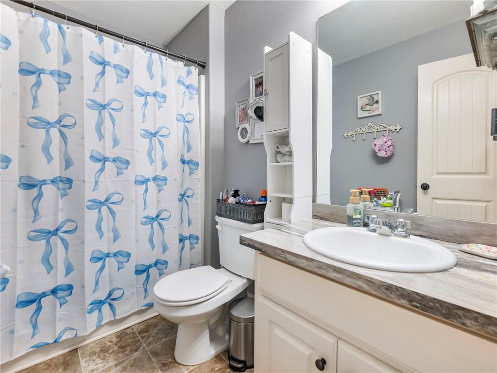 476 River Mist Circle Jefferson, GA 30549 - Photo 22 of 44 a bathroom with a sink a toilet and shower curtain