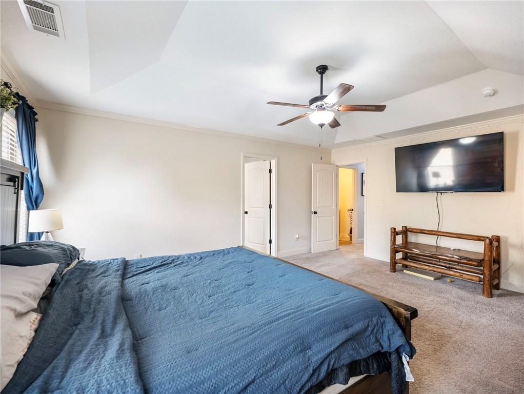 476 River Mist Circle Jefferson, GA 30549 - Photo 25 of 44 a bedroom with a bed a flat screen tv and couches