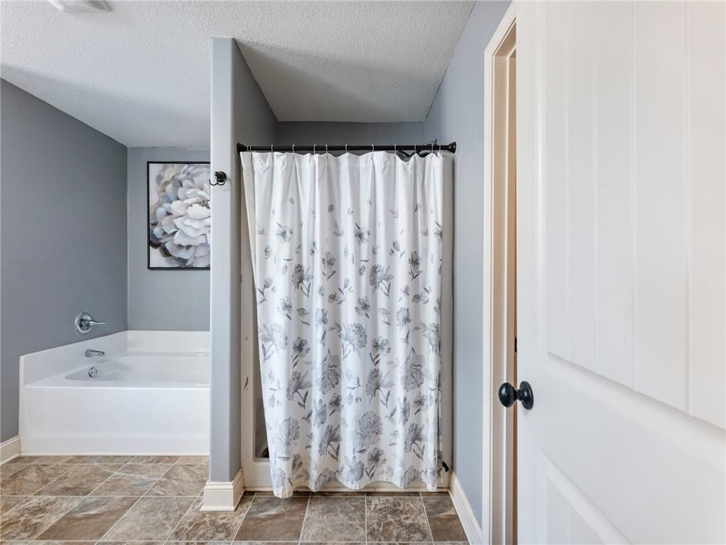 476 River Mist Circle Jefferson, GA 30549 - Photo 26 of 44 a bathroom with a bathtub and shower