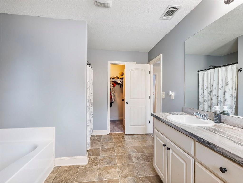 476 River Mist Circle Jefferson, GA 30549 - Photo 28 of 44 a bathroom with a granite countertop sink and a mirror