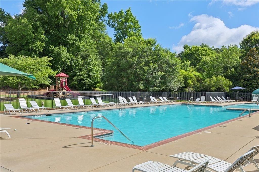 476 River Mist Circle Jefferson, GA 30549 - Photo 41 of 44 a view of a swimming pool with a bench and some trees