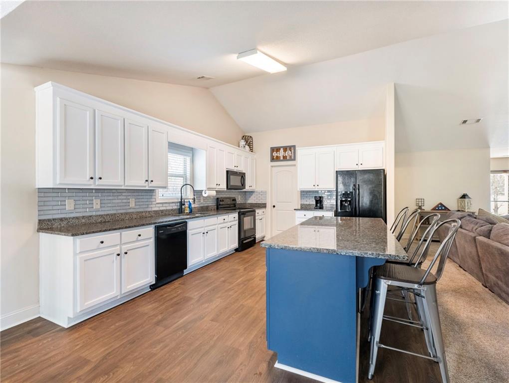 476 River Mist Circle Jefferson, GA 30549 - Photo 7 of 44 a large kitchen with cabinets wooden floor and stainless steel appliances