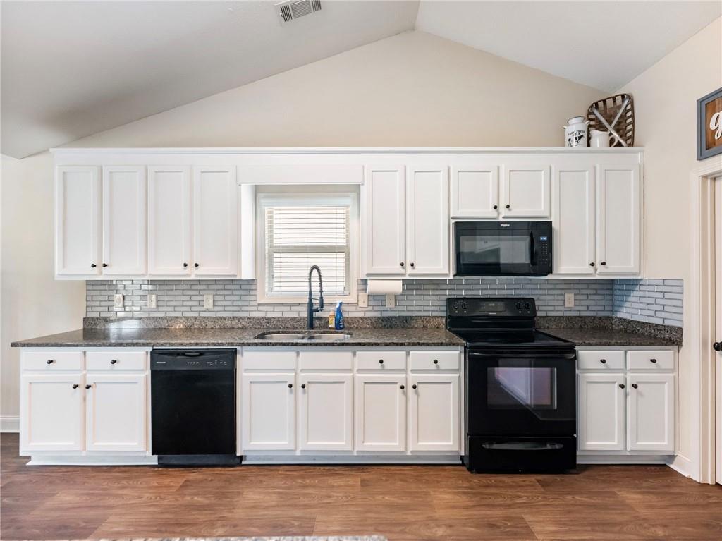 476 River Mist Circle Jefferson, GA 30549 - Photo 8 of 44 a kitchen with granite countertop white cabinets and stainless steel appliances