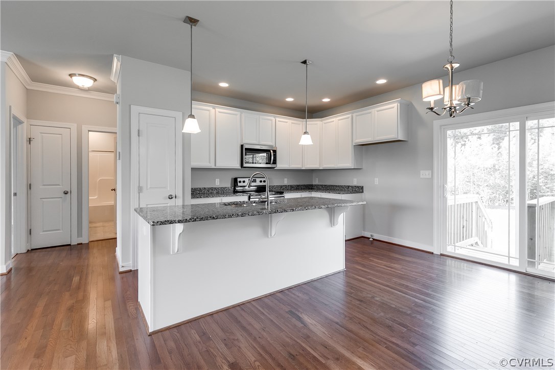 90 Hickory Ridge Circle Mineral, VA 23117 - Photo 5 of 23 a kitchen with stainless steel appliances granite countertop a refrigerator a sink dishwasher a stove and white cabinets with wooden floor