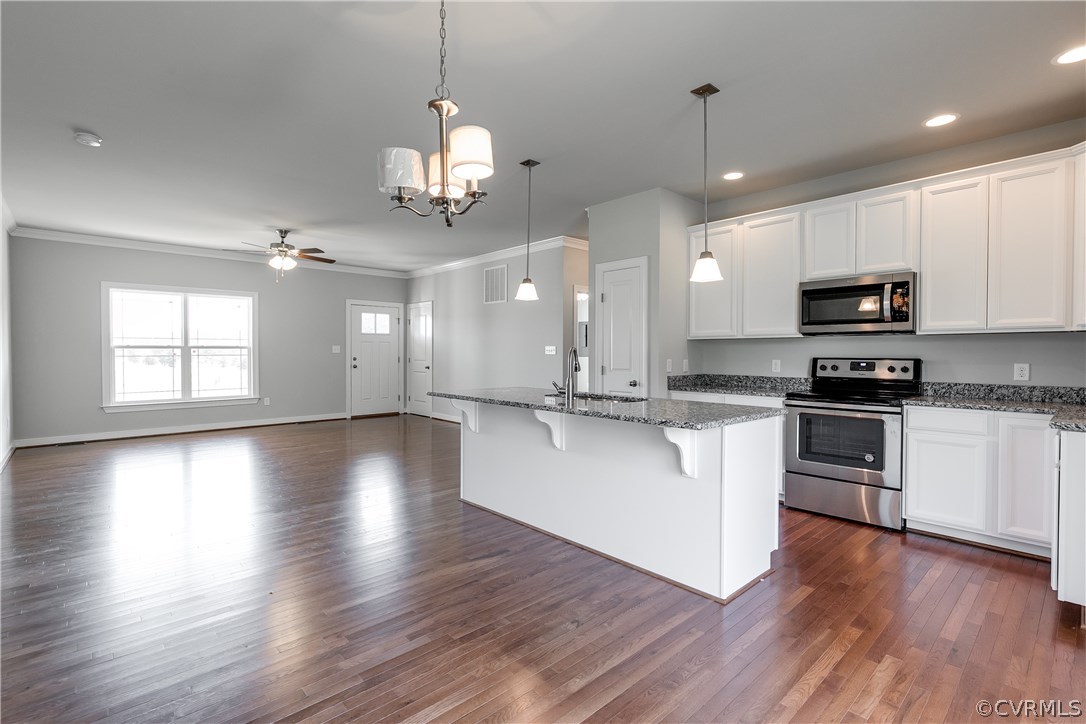 90 Hickory Ridge Circle Mineral, VA 23117 - Photo 7 of 23 a large kitchen with hardwood floor stainless steel appliances and white cabinets