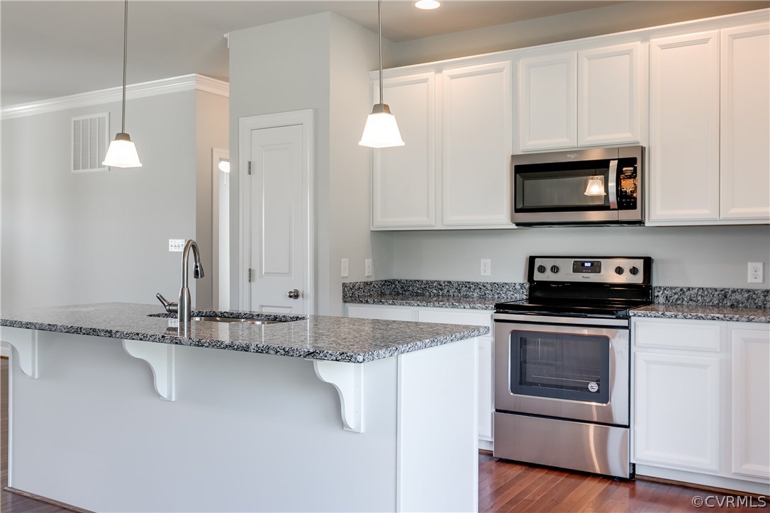 90 Hickory Ridge Circle Mineral, VA 23117 - Photo 8 of 23 a kitchen with granite countertop a sink a stove and microwave