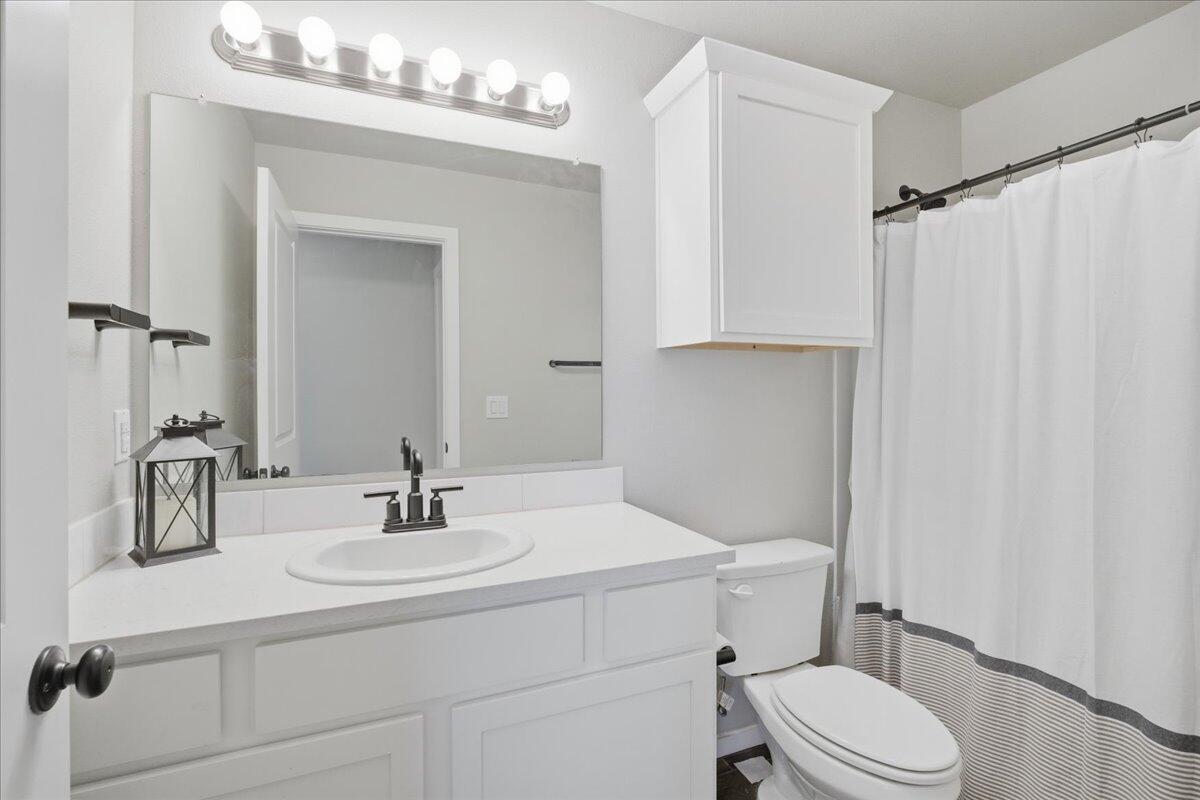 9807 Virginia Avenue Lubbock, TX 79424 - Photo 19 of 39 a bathroom with a sink toilet and shower
