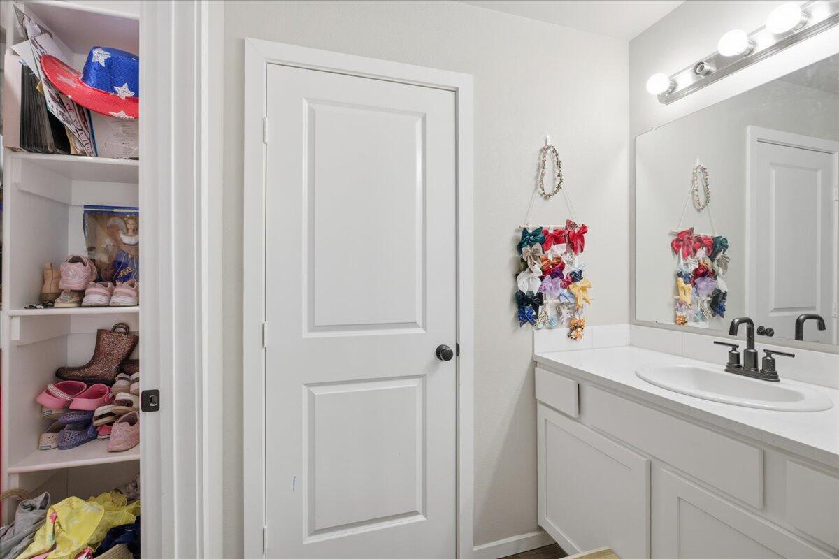 9807 Virginia Avenue Lubbock, TX 79424 - Photo 22 of 39 a bathroom view of a sink and a mirror