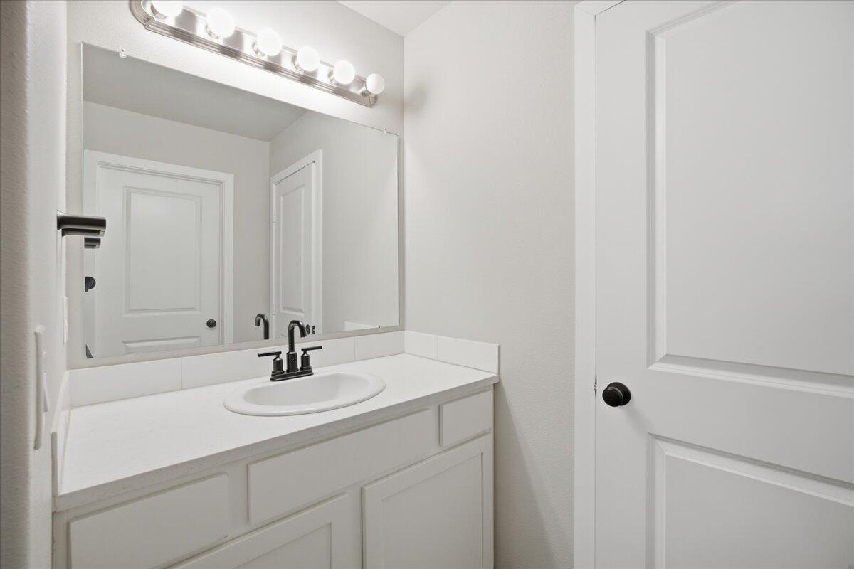 9807 Virginia Avenue Lubbock, TX 79424 - Photo 24 of 39 a bathroom with a sink and a mirror