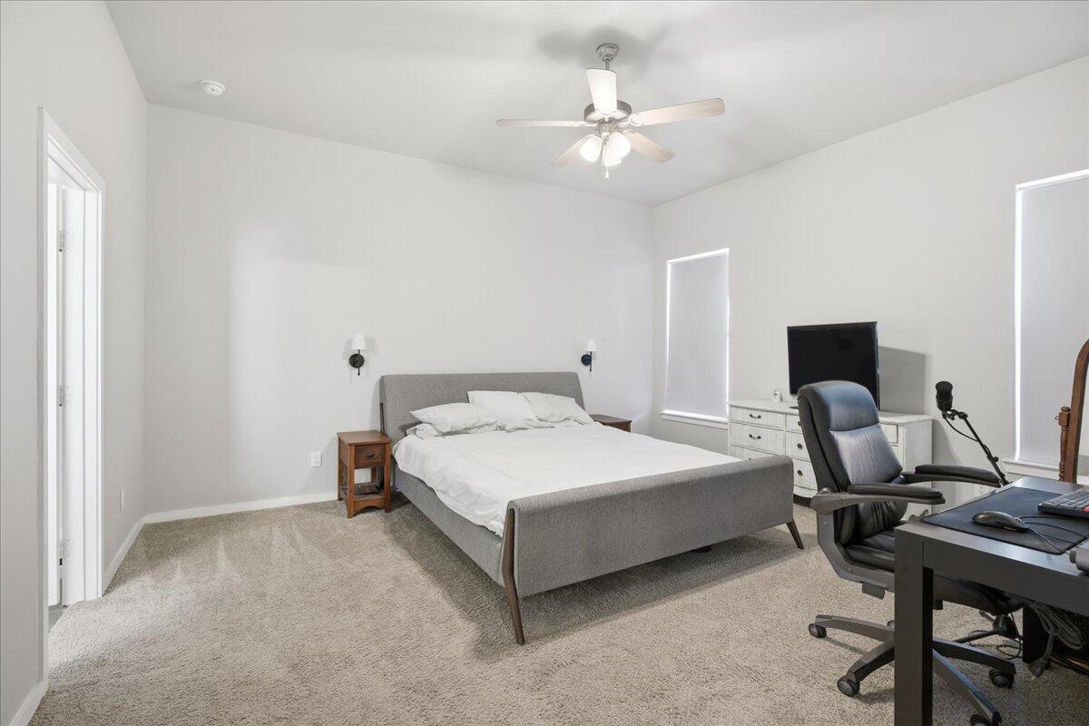 9807 Virginia Avenue Lubbock, TX 79424 - Photo 25 of 39 a bedroom with a bed a desk and chair