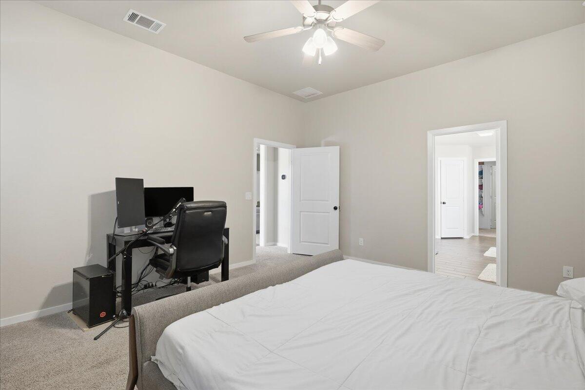 9807 Virginia Avenue Lubbock, TX 79424 - Photo 26 of 39 a bedroom with a bed and a chandelier