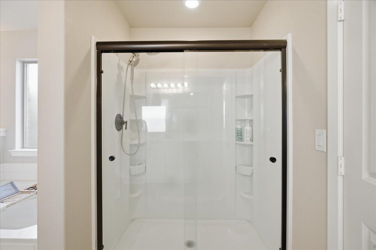 9807 Virginia Avenue Lubbock, TX 79424 - Photo 30 of 39 a bathroom with a glass shower door
