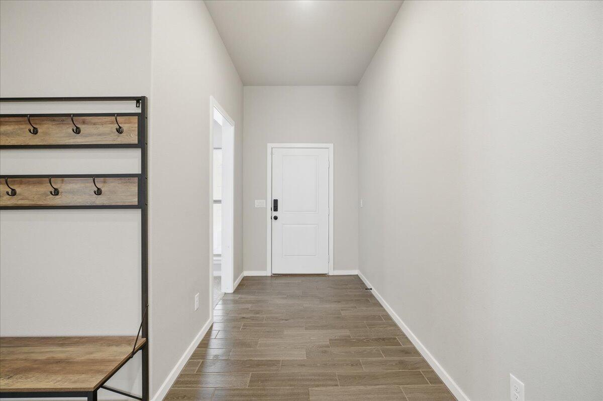 9807 Virginia Avenue Lubbock, TX 79424 - Photo 3 of 39 a view of a hallway with wooden floor