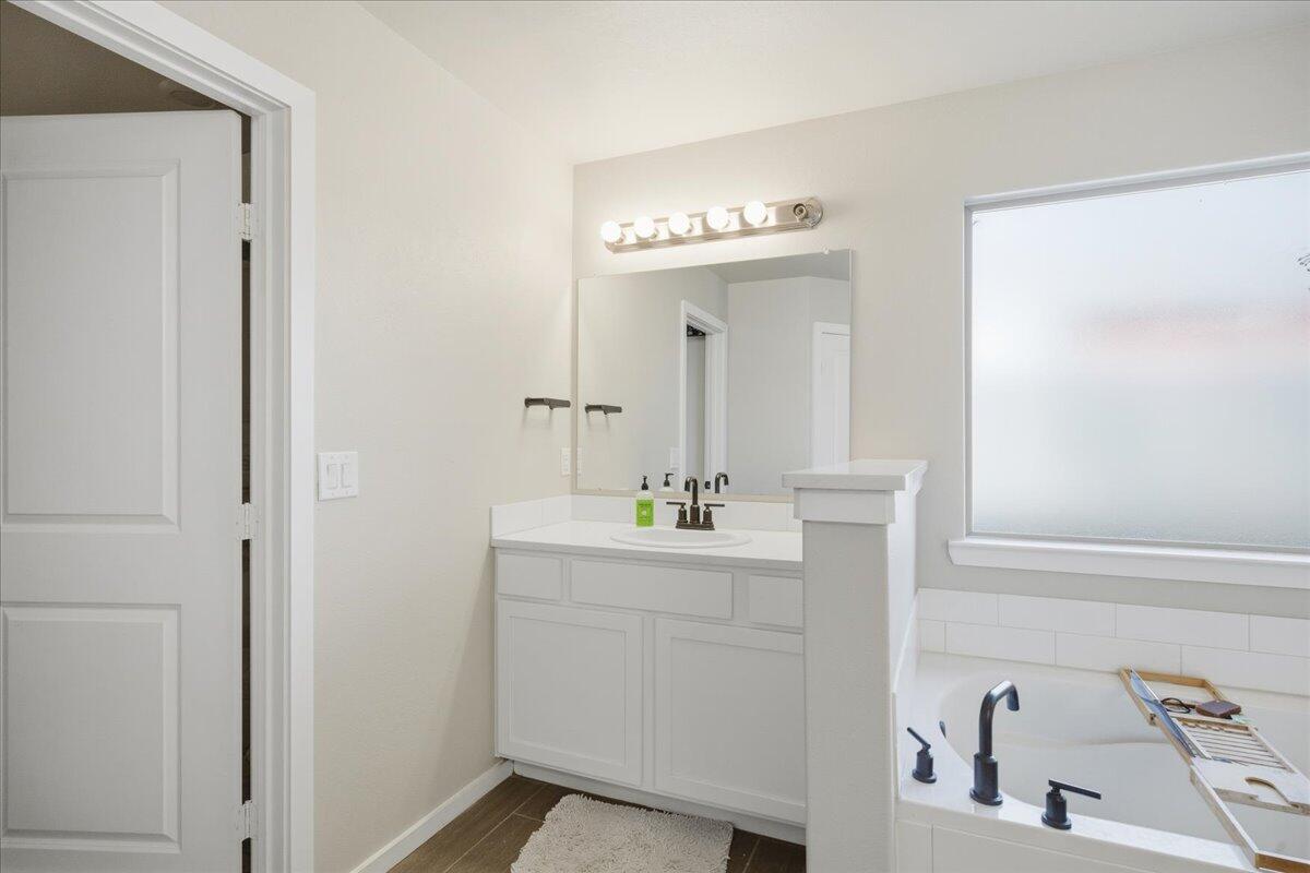 9807 Virginia Avenue Lubbock, TX 79424 - Photo 31 of 39 a bathroom with a sink and a mirror