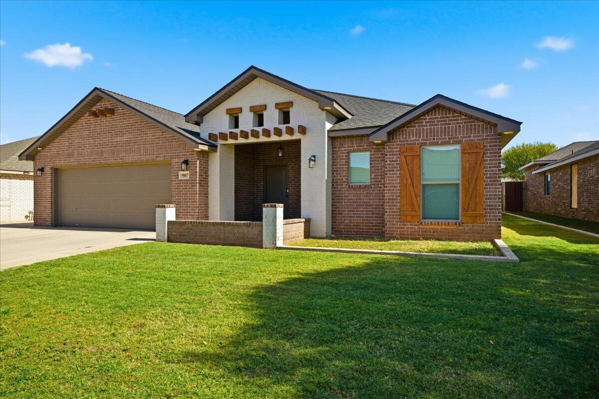 9807 Virginia Avenue Lubbock, TX 79424 - Photo 39 of 39 a front view of a house with a yard and garage