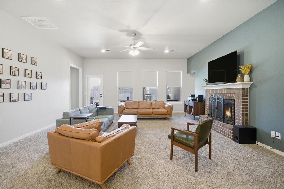 9807 Virginia Avenue Lubbock, TX 79424 - Photo 4 of 39 a living room with furniture and a fireplace